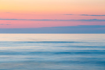 sunset on the beach with a wooden breakwater, long exposure