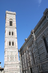 Fototapeta na wymiar Giottos Campanile and Cathedral Santa Maria under blue sky in Florence, Tuscany Italy 