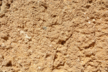 A piece of stone ,the old walls of the fortress in the background 
