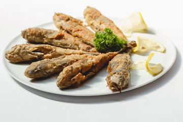 Fried fishes on white background for the menu