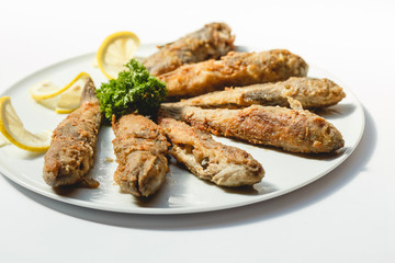 Fried fishes on white background for the menu
