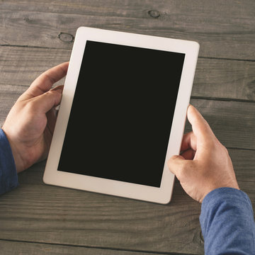 Man holding tablet with blank screen