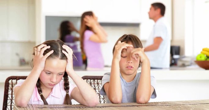 Sad children listening to their parents fighting