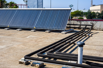 Vacuum solar cells for water heating system on the pool roof
