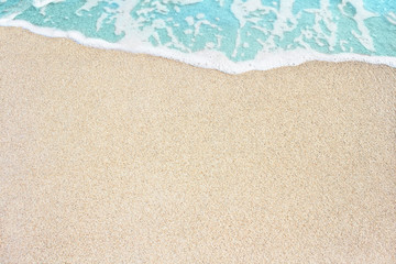 Fototapeta na wymiar Soft ocean wave on the sandy beach, background.