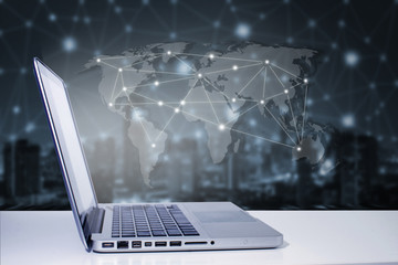 technology concept,computer labtop with world map on city connec