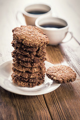 Oatmeal cookies and coffee on the wooden table