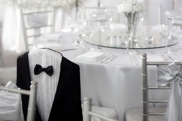 Dress groom prepared to decorate the chairs prepared for his wedding.