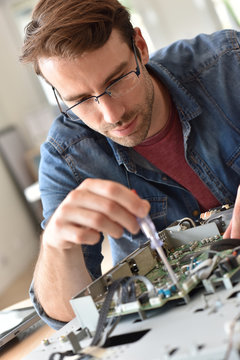 Repairman fixing tv set