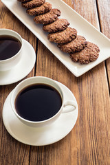 Oatmeal cookies and coffee on the wooden table