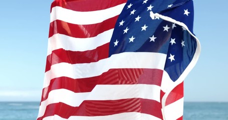 Senior man holding american flag - Powered by Adobe