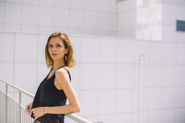 beautiful slim girl in shorts and t-shirt standing on bolkone looking into the distance