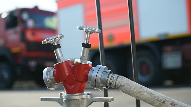 Water hose connected to hydrant during firefighting operation