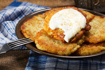 Homemade potato pancakes served with sour cream and brown sugar