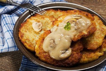 Homemade potato pancakes served with mushroom sauce and mushroom