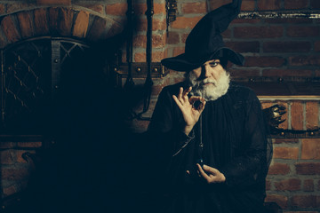 Old wizard with pendulum