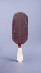 Ice cream with chocolate coating isolated on the gray background