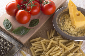 Pasta, tomatoes, basil and grated cheese.