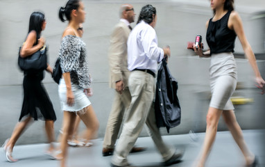 motion blurred business people walking on the street