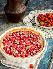 Pie with strawberry on vintage blue background.