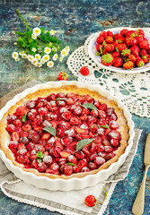 Pie with strawberry on vintage blue background.