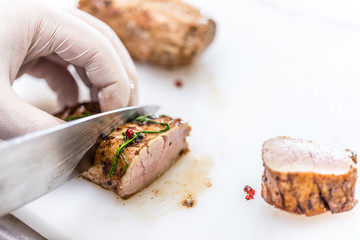 Chef cuts loin pork meat
