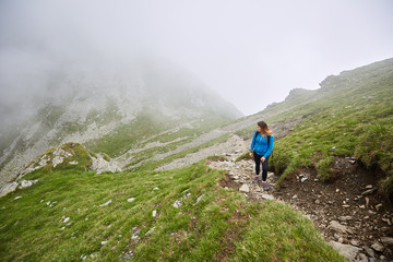 Fototapeta premium Woman backpacker hiking on a trail