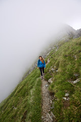 Woman backpacker hiking on a trail