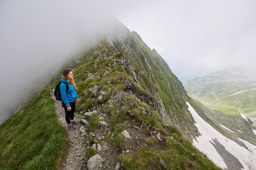 Fototapeta premium Woman backpacker hiking on a trail