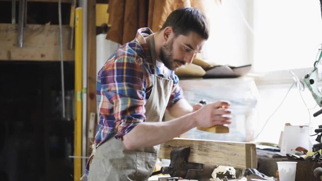 carpenter working with plane and wood at workshop