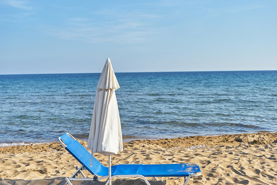 Beach chairs with umbrella and beautiful beach on a sunny day