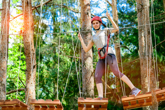 adventure climbing high wire park - Young woman on course in mou