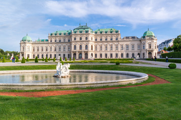 Belvedere gardens with pool, people and Upper Belvedere Palace in Vienna, Austria