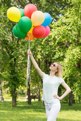 happy woman in the park with balloons.