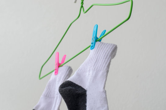 White sock drying on a clothes line.