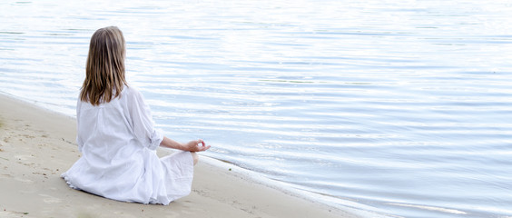 Woman meditating at the sea