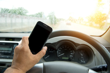 People play smart phones  while driving tha car,road's raining u
