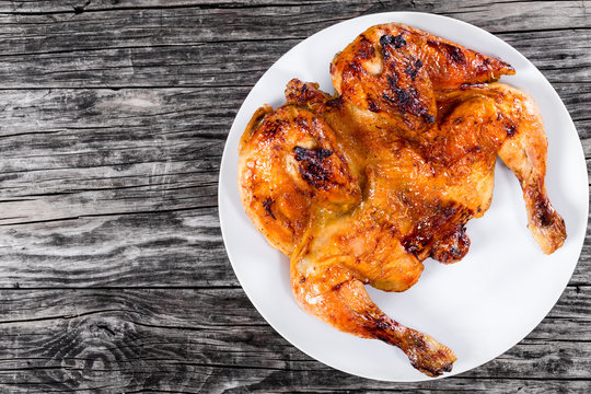 roasted whole chicken on white plaet, top view