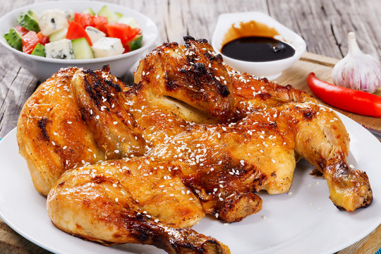 Grilled whole chicken and salad in white bowl