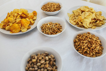 Salty appetizers lie on white plates