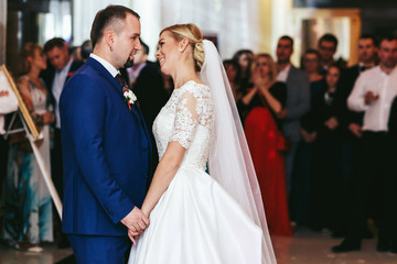 Bride and groom stand in the middle of a dance floor