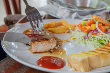 Close up of cut the chicken steak in dish.