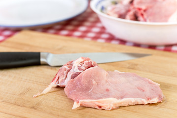 Pork chops on the cutting board with knife