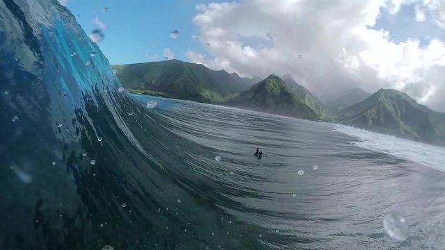 SLOW MOTION: Extreme photographer filming pro surfer riding tube wave