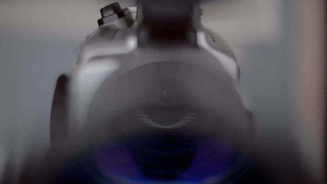 The camera turns around and in the lens reflected circular light sources 