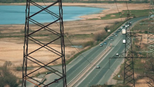 Electric poles in barren wasteland near the high way in Ukraine