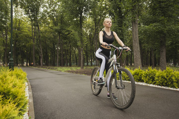 A girl rides a Bicycle on the bike path