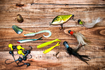 Fishing baits isolated on wooden background