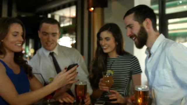 Happy friends taking selfie together in bar