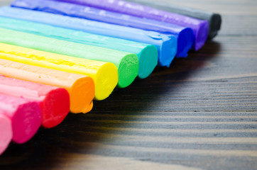 Fototapeta premium A colorful of a plasticine on wooden ground